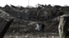 FILE: International and Afghan investigators at the site of a powerful truck bomb blast that targeted a hotel used by foreign contractors in Kabul.
