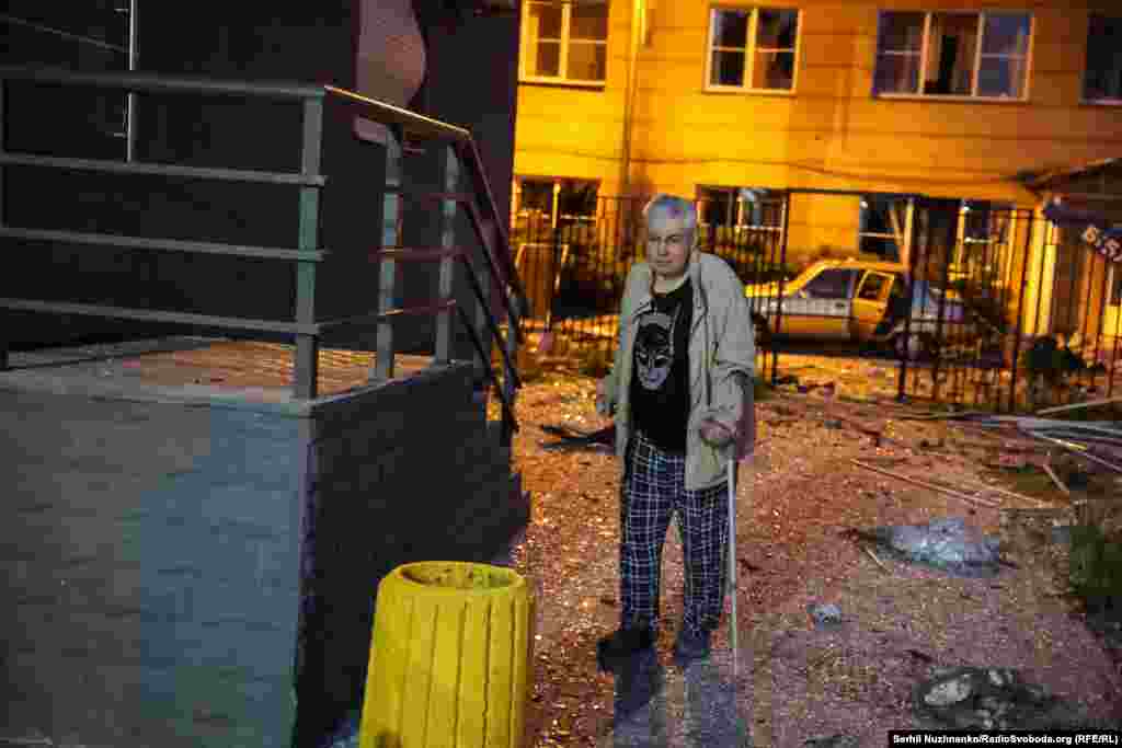 A local resident is photographed shortly after his apartment buiding was struck during the Russian attacks.