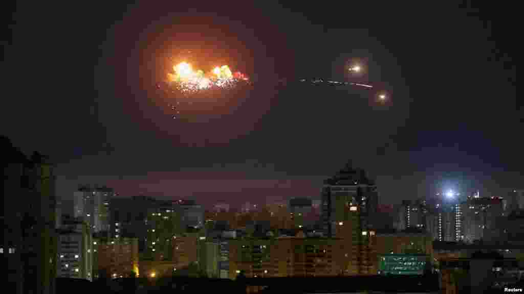 A ballistic missile explodes in the sky over the city during a Russian drone strike in Kyiv.Ukraine's military said more than 210 missiles and drones were launched in the overnight assault on April 24, including ballistic missiles and cruise missiles launched by heavy bombers and Black Sea naval ships.