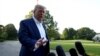 US President Donald Trump speaks with reporters before departing for the NATO summit in the Netherlands.