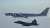 A Russian Tu-142 maritime reconnaissance aircraft (top) is intercepted near the Alaska coastline. (file photo)