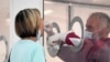 This photo taken and provided by Italian news agency ANSA on June 26, 2020 shows a citizen (L) undergoing a voluntary swab test for COVID-19 